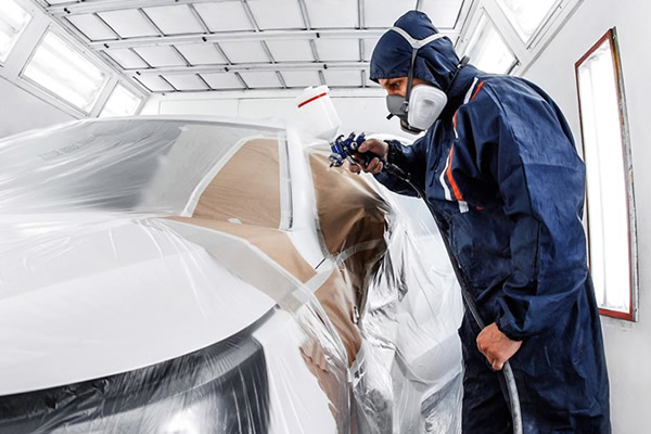 Image of a body work employee working on a car