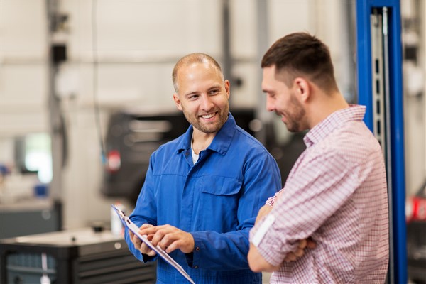 Image of two men talking about the status of his car